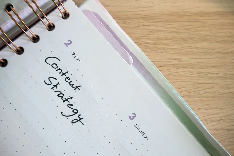 Close-up view of handwritten Marketing Strategy text with an arrow against a white background.