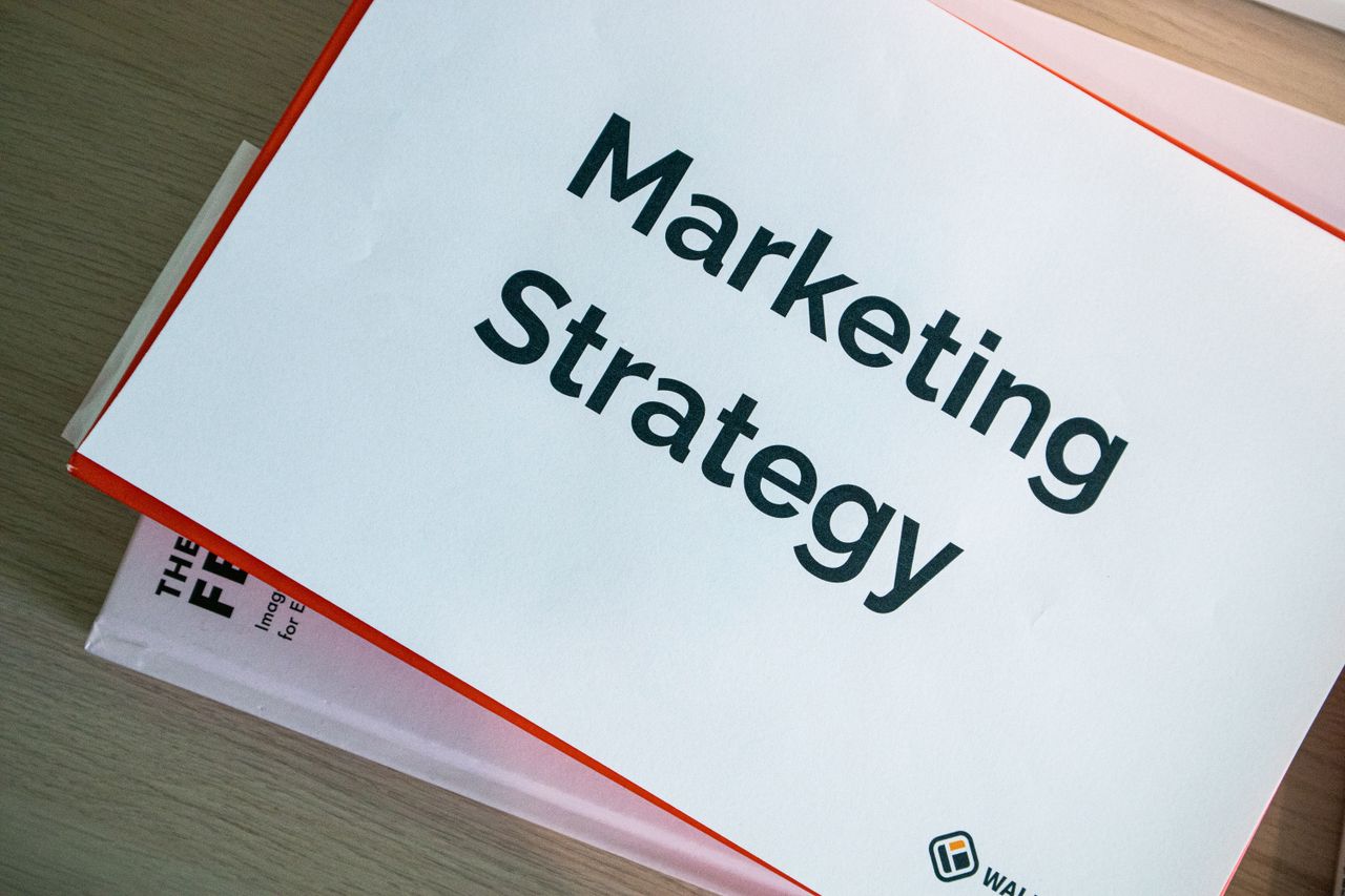 our-story A marketing strategy document displayed on a desk, showcasing business planning essentials.